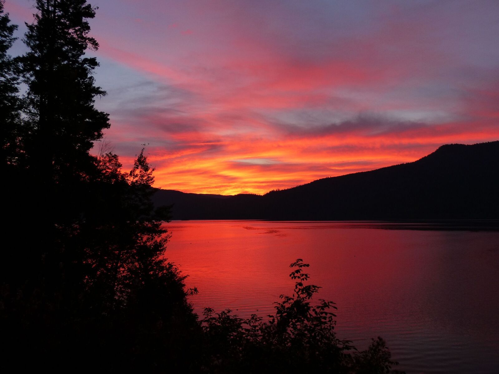A luxury lakeside property at sunset, illustrating the commercial case for regenerative luxury hospitality