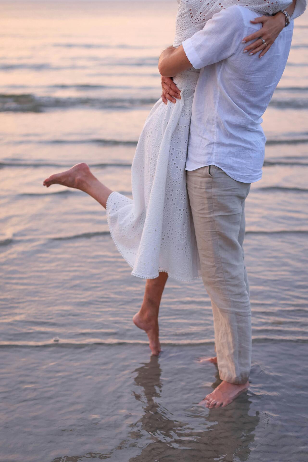A couple toasting at sunset on the beach — the kind of authentic, place-rooted story RL Marketing tells