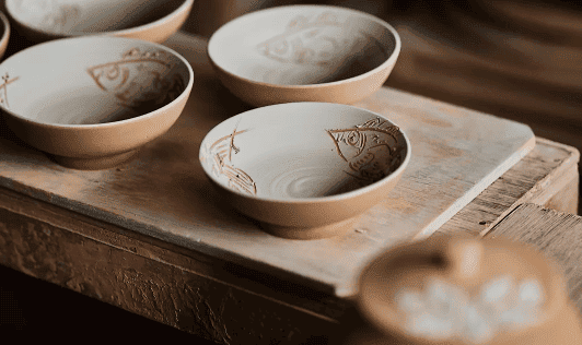 Tsuboya pottery bowls crafted by the Kinjo family, showcasing Okinawa’s ceramic traditions at Rosewood Miyakojima, blending cultural heritage with sustainable luxury.